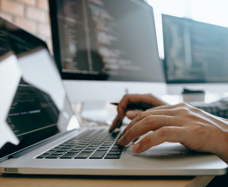 contemporary website developer man typing and writing code for program website